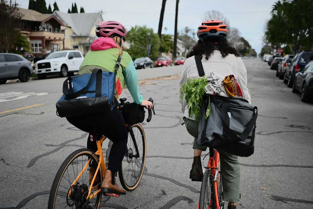 Everything Tote Bag in Grey and Navy Cordura being used as bicycle commuting bags.