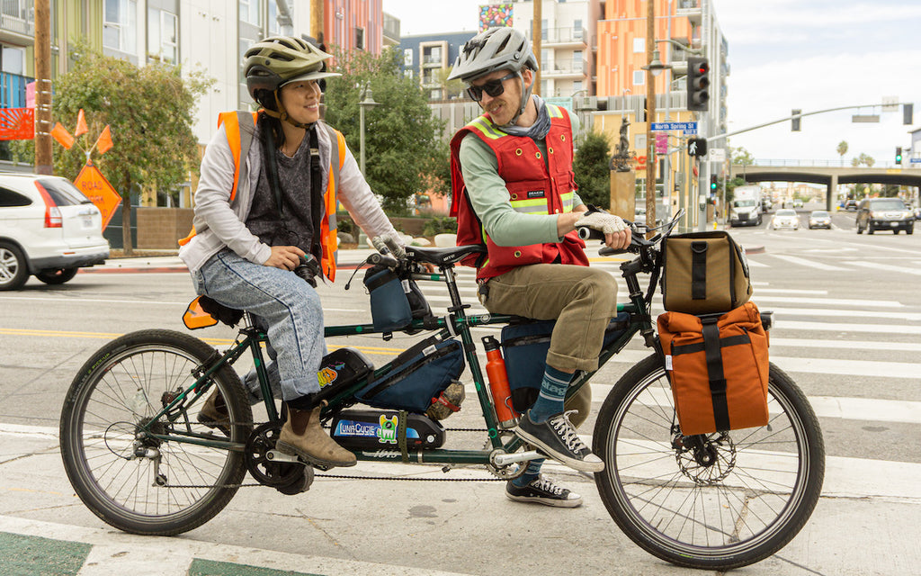 Road Runner Bags Founders are shown on their ebike tandem while waiting at a red light in Downtown Los Angeles